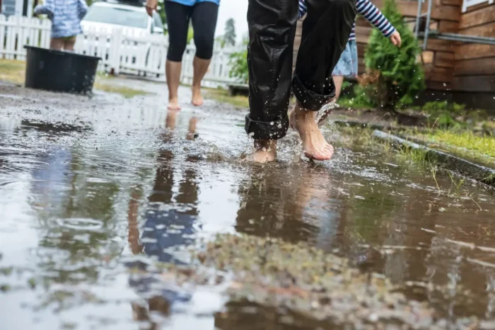 people walking down a flooded street in Thailand