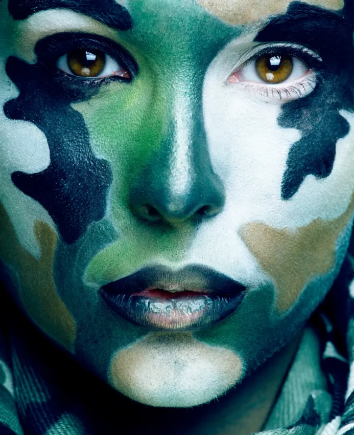 military woman with camouflage paint on face