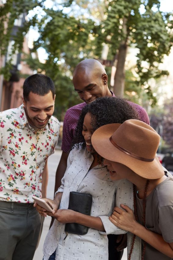 group of friends looking at map on mobile phone