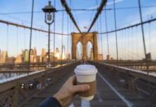 me drinking coffee in New York city on the bridge