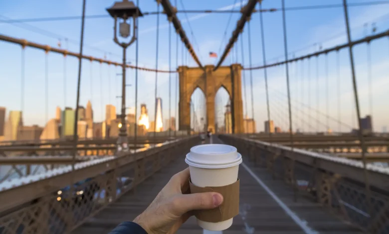 me drinking coffee in New York city on the bridge